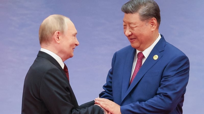 Russia's President Vladimir Putin and Chinese President Xi Jinping greet each other during a welcoming ceremony of the Shanghai Cooperation Organisation Summit