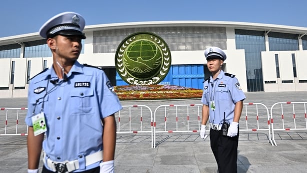 Police officers stand guard outside a building