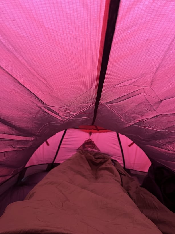 A view from inside a tent, with daylight filtering through