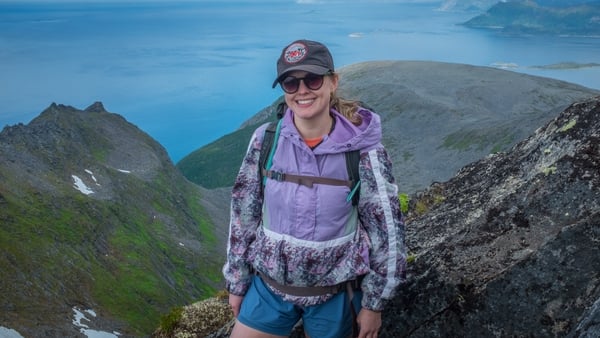 A photo of Anna Cullen with mountains behind her
