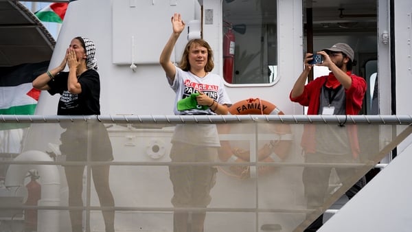 Climate activist Greta Thunberg is seen waving goodbye while setting sail with the Global Sumud Flotilla from the Port of Barcelona