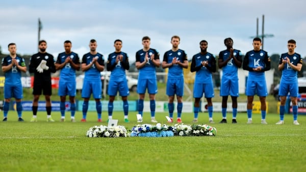 29 August 2025; The Finn Harps team stands for a minute's applaus in remembrance of the late former Finn Harps manager Ollie Horgan before the SSE Airtricity Men's First Division match between Finn Harps and Treaty United at Finn Park in Ballybofey, Doneg
