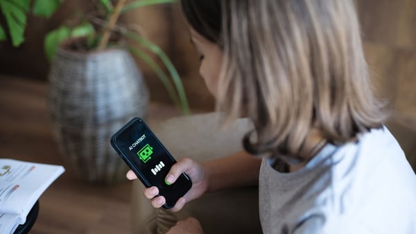 A girl asking AI Chatbot mobile app questions using her smart phone