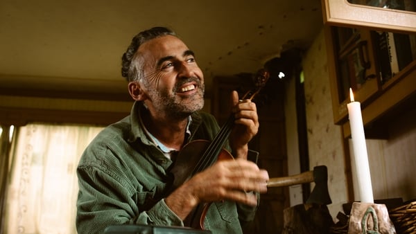 Aindrias de Staic smiling with fiddle candle by Anthony O Connor