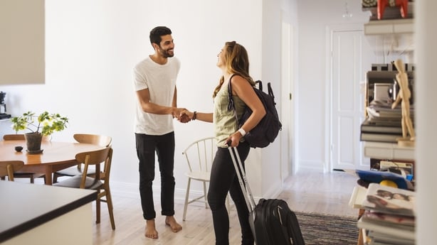 new room mates meeting and shaking hands