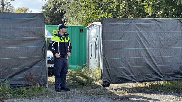 A garda stands outside an area cordoned off while a search is carried out as part of an investigation into the disappearance of a young boy in Dublin