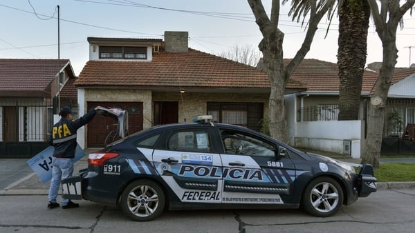 A member of the Argentine Federal Police stands outside the house that was raided after a photo showing a 17th century masterwork allegedly stolen by the Nazis from a Dutch Jewish art collector