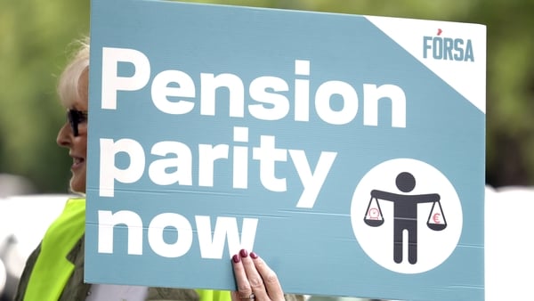 A woman holds up a Forsa sign on the picket line at a strike in Dublin