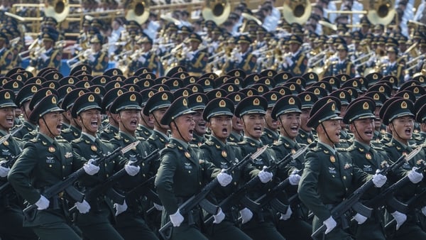 Chinese Soldiers march in unison in green uniform
