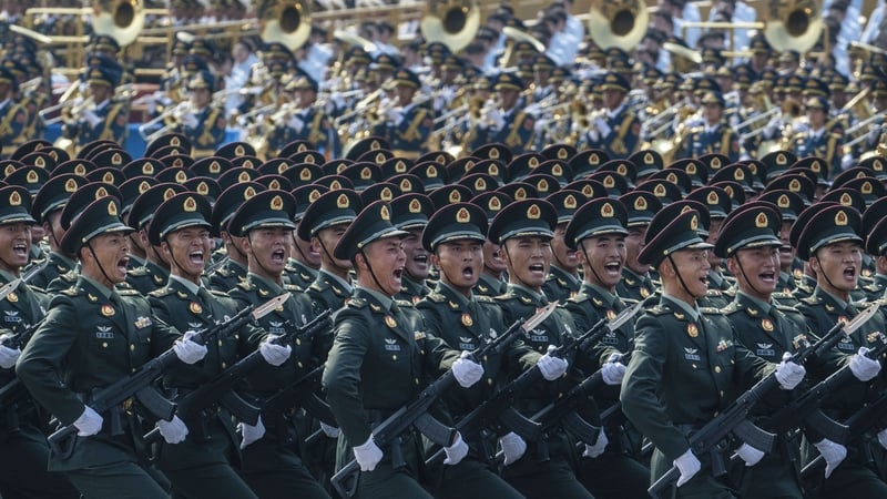 Chinese soldiers shout as they march during the military parade