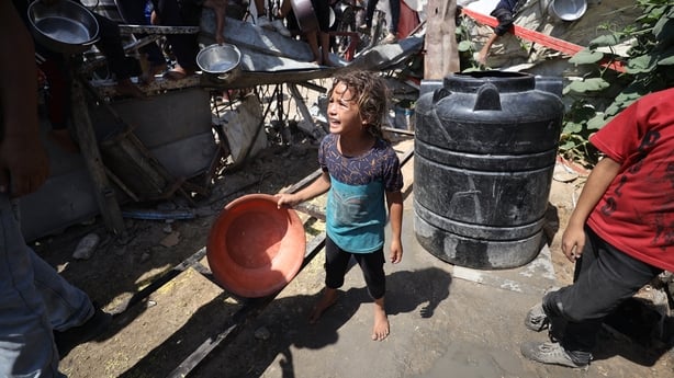 GAZA CITY, GAZA - SEPTEMBER 3: Palestinians carry pans and bowls forms a crowd to receive food aid provided by charity organization in Gaza City, Gaza on September 3, 2025. Due to the blockade imposed by Israel on the Gaza Strip and the ongoing attacks, Palestinians facing difficulties in accessing 