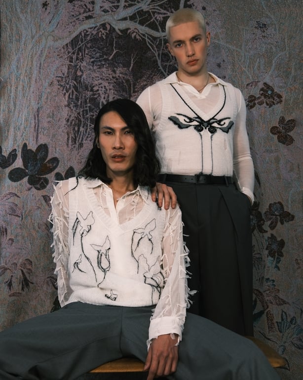 Two models wearing white and black knitted tops