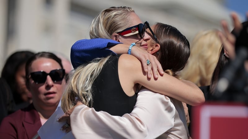 Survivors Chauntae Davies and Anouska De Georgiou embrace during a news conference with alleged victims of Jeffrey Epstein