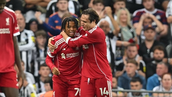Liverpool's English striker #73 Rio Ngumoha (C) celebrates with Liverpool's Italian striker #14 Federico Chiesa (R) after scoring their third goal during the English Premier League football match between Newcastle United and Liverpool at St James' Park in