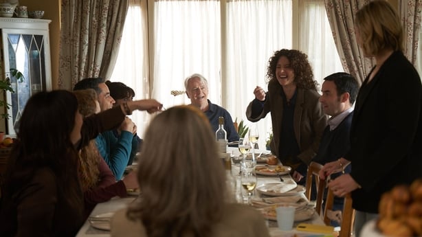The family and Aidan are around the dinner table celebrating