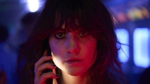 Caroline Menton as Rachel on the phone at the bar