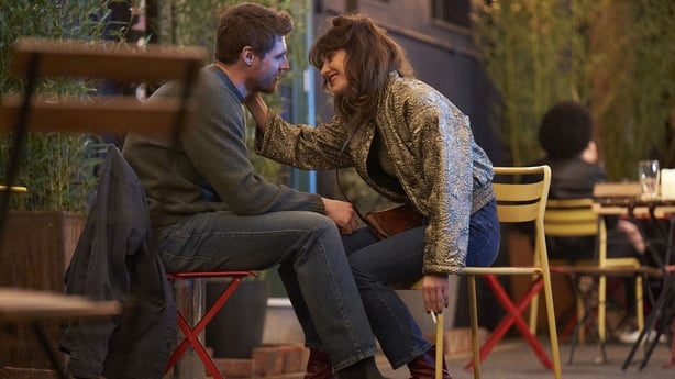 Jay Duffy as Luke and Caroline Menton as Rachel sitting in the outside smoking area of the nightclub