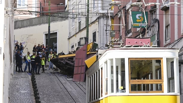 Emergency services inspect the area surrounding the wreckage of a funicular