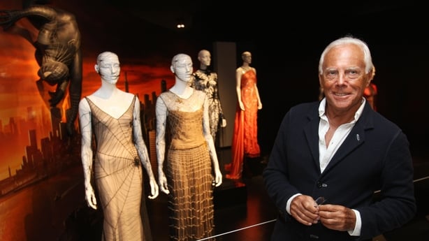 TO GO WITH AFP STORY:Entertainment-US-museum-Capes and spandex: Met explores fashionable superheroes by Paola MESSANA. Designer Giorgio Armani poses May 5, 2008 with one of his creations from 1990 (2nd L) and one from John Galliano (L) from 1997 during a preview of "Superheroes: Fashion and Fantasy"