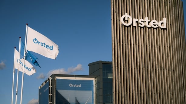 Flags with a company logo flying outside an office building 