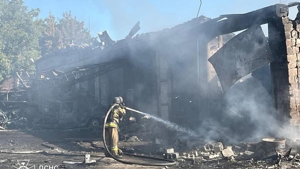 Ukrainian firefighters at site of damaged building
