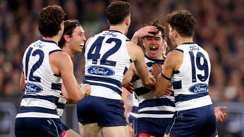 Oisín Mullin is congratulated by Geelong Cats team-mates after his goal against Brisbane Lions