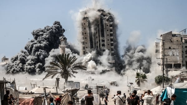 Smoke and dust rise from Mushtaha Tower in Gaza City after it was hit by Israeli airstrikes in Gaza