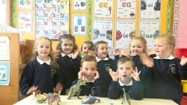 Four sets of twins wave to the camera at Four Masters Primary School, Co Leitrim