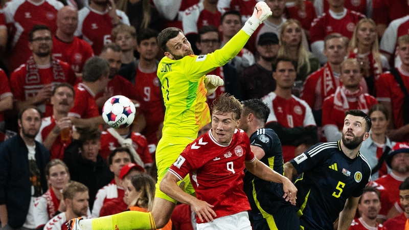 Scotland goalkeeper Angus Gunn punches clear under pressure from Denmark's Rasmus Hojlund