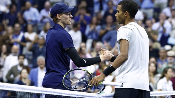 Italy's Jannik Sinner (L) shakes hands with Canada's Felix Auger-Aliassime after winning their men's singles semifinal tennis match on day thirteen of the US Open tennis tournament at the USTA Billie Jean King National Tennis Center in New York City