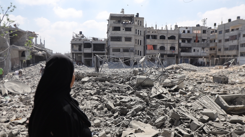 Palestinians inspect what remains of their homes in the al-Amal neighbourhood of Khan Younis after Israeli attacks