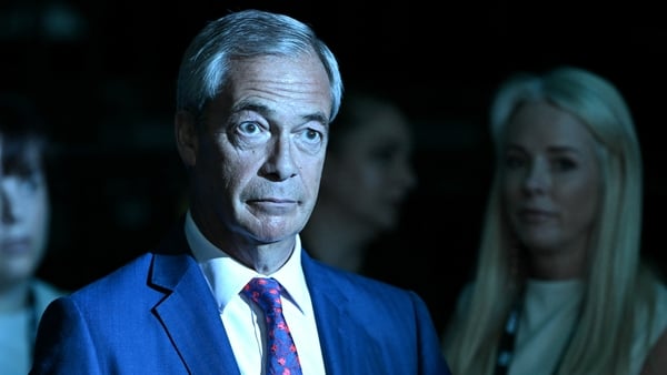 Nigel Farage looks on before delivering his closing remarks on the second and final day of the Reform UK party conference