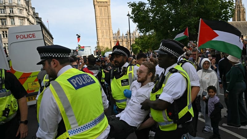 A protester is carried away by police officers at a 'Lift The Ban' demonstration in support of the proscribed group Palestine Action