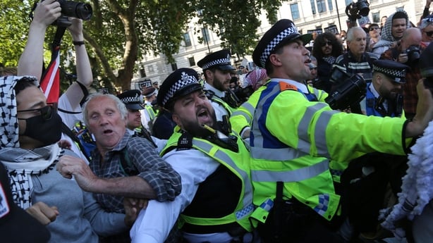 Police officers and protesters scuffle