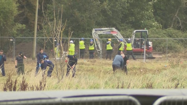Gardaí, one using a digger, search for missing boy in a cordoned off area in Co Dublin