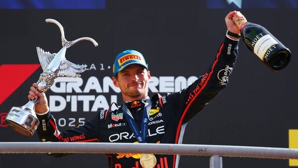 MONZA, ITALY - SEPTEMBER 07: Race winner Max Verstappen of the Netherlands and Oracle Red Bull Racing on the podium with his trophy during the F1 Grand Prix of Italy at Autodromo Nazionale Monza on September 07, 2025 in Monza, Italy. (Photo by Clive Rose/