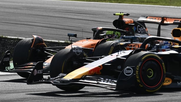 Red Bull Racing's Dutch driver Max Verstappen corners past McLaren's British driver Lando Norris during the Italian Formula One Grand Prix at the Autodromo Nazionale Monza circuit, in Monza, northern Italy, on September 7, 2025.