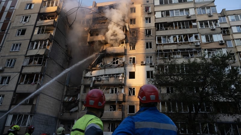 Firefighters put out a fire on a residential building that killed three people following a Russian strike on Kyiv, Ukraine