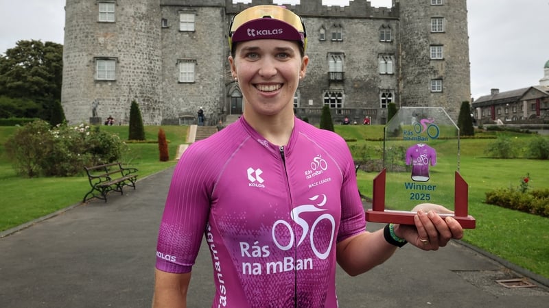 Alice McWilliam celebrates winning the 2025 Rás na mBan in front of Kilkenny Castle (Picture credit: Lorraine O'Sullivan)