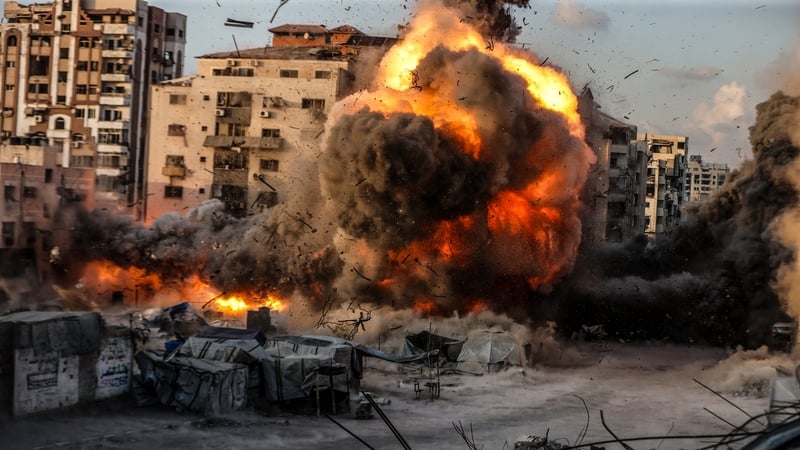 Flames and smoke rise following an Israeli army strike on the al-Ruya Tower in Gaza City