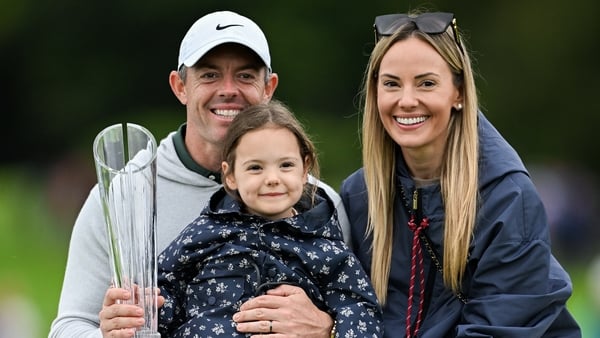 Rory McIlroy of Northern Ireland celebrates with wife Erica Stoll and daughter Poppy and the Amgen Irish Open Championship trophy after victory in the final round of the Amgen Irish Open Golf Championship 2025 at The K Club