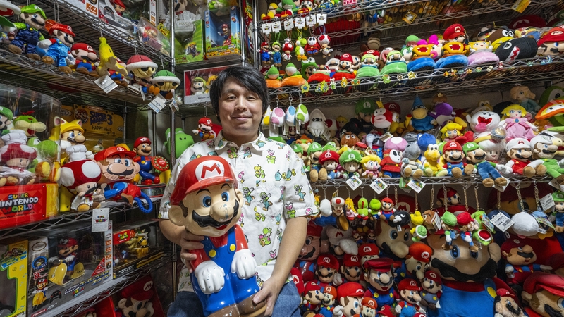 Super Mario collector Kikai posing for photographs ahead of the 40th anniversary of the Nintendo mascot