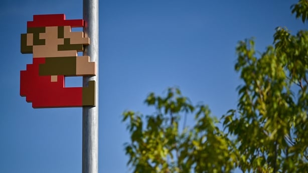 Super Mario on a pole in the courtyard during a media preview of the new Nintendo Museum