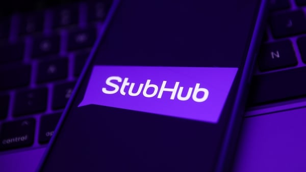 A laptop keyboard and StubHub logo displayed on a phone screen