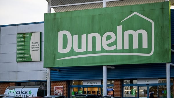 A green sign above an entrance to a Dunelm Group store