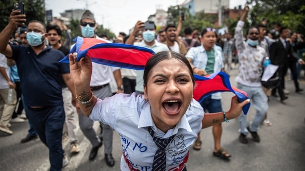 A demonstrator shouts slogans during a protest outside the Parliament in Kathmandu