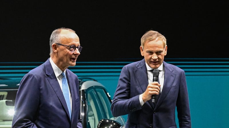 Oliver Blume (R), CEO of Volkswagen Group and German Chancellor Friedrich Merz at the VW booth at the IAA in Munich today