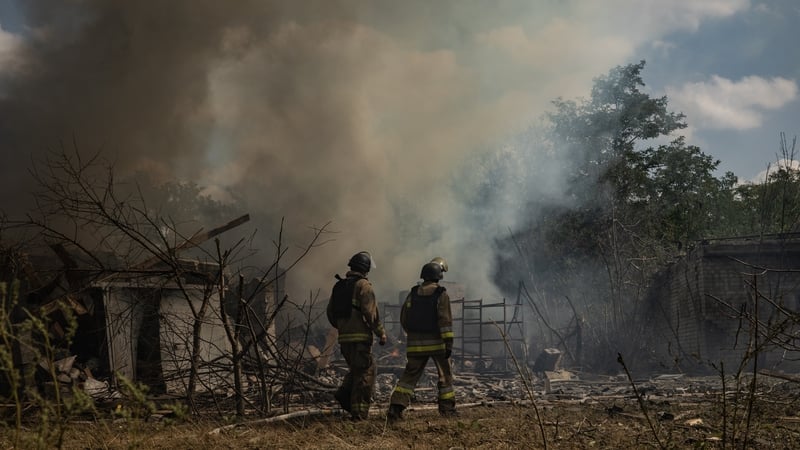 Firefighters walk in front of fire at residential district after Russian air attack on Kramatorsk, Ukraine yesterday