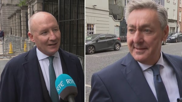 Jim Gavin speaks to someone off camera with an RTÉ mic in front of him, while Billy Kelleher gestures to someone off camera