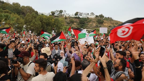 Hundreds of people gather at the port to welcome the boats, that joined the Global Sumud Flotilla, which set sail from Spain to show solidarity with Palestinians, arrive off the coast of Tunisia